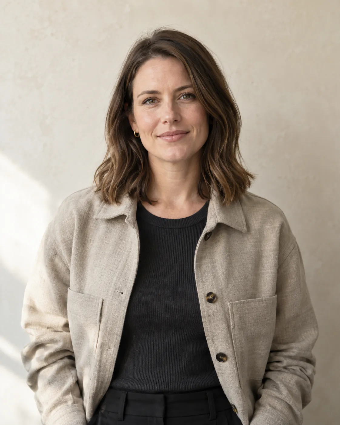 AI-generated placeholder portrait of a fictional team member wearing a stone-coloured overshirt.