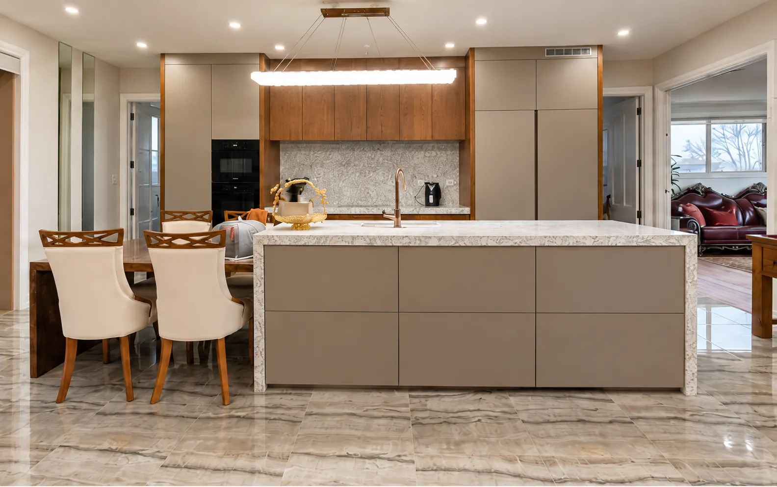 AI-retouched project photograph: the Whitford kitchen with a taupe island, timber upper cabinets, stone surfaces and an adjoining dining area.